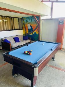 a pool table with balls on it in a room at Casa Escalante Hostel in San José