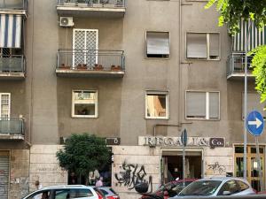 a building with cars parked in front of it at Ulivo Guest House Roma in Rome
