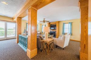 a living room with a table and some chairs at By the Sea in Kill Devil Hills