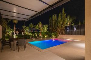 ein Swimmingpool in einem Hinterhof bei Nacht in der Unterkunft Villa Meraki in Marrakesch