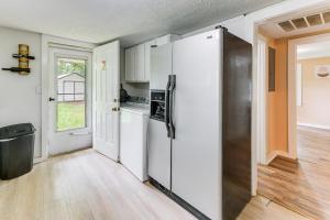 a kitchen with a refrigerator and a window at 6 Mi to Museum of Aviation Rural Kathleen Home in Bonaire