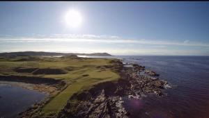 an aerial view of a golf course near the ocean at Joe and Aggies in Kilclooney