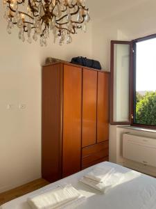 a bedroom with a table and a chandelier at Livorno 3X3 in Livorno