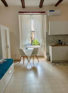 a bedroom with a bed and a table and a window at TiTò Apartment in Naples