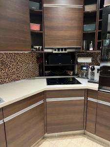 a kitchen with wooden cabinets and a stove top oven at chez Kay in Vétraz-Monthoux