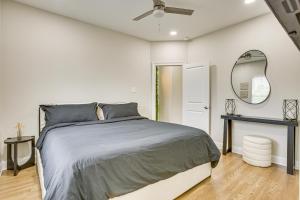 Un dormitorio con una cama grande y un espejo. en Walk to Carrollton Ave Eats Bright NOLA Duplex!, en Nueva Orleans