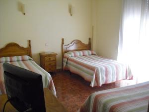 Postel nebo postele na pokoji v ubytování Hostal Sunami