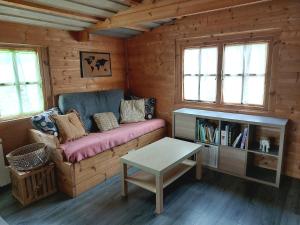 a living room with a couch and a table at Pause nature au cœur des forêts in Saint-Pal-de-Senouire