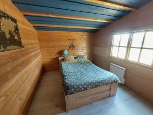 a bedroom with a bed in a wooden room at Pause nature au cœur des forêts in Saint-Pal-de-Senouire