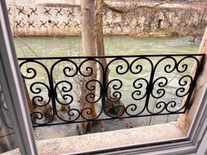 a balcony with a view of a river from a window at Le loft sur rivière in Dijon