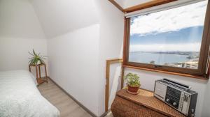 a bedroom with a window and a tv on a table at Hostal La Cofa in Viña del Mar