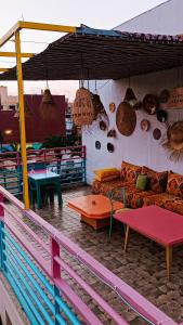 a patio with a couch and tables and pendant lights at Riad SULTANA lateral seaview in Saïdia