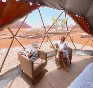 a woman sitting in a chair on a boat at DESERT BREATHS lUXURY CAMP in Wadi Rum