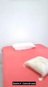 a red table with two pillows on top of it at Casa Alcobaça in Alcobaça