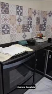 a kitchen with a stove and a counter with tiles at Casa Alcobaça in Alcobaça