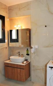 a bathroom with a sink and a mirror at Meteora Guest Houses in Kalabaka