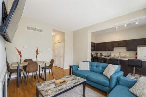 a living room with a couch and a table at Stylish 2BR Apartment with Private Balcony near Soulard in Soulard