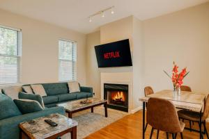 a living room with a couch and a fireplace at Stylish 2BR Apartment with Private Balcony near Soulard in Soulard