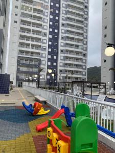 a playground with colorful play equipment in a city at Apartamento de frente ao mar in Mongaguá