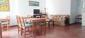a living room with a table and chairs and a couch at El balcón de Alange in Alange