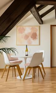 a dining room with a table and two chairs at STAYS Bodensee Apartments in Stetten