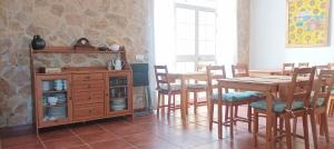 a dining room with a wooden table and chairs at El balcón de Alange in Alange