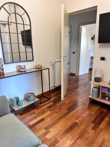 a living room with a couch and a wooden floor at La casetta bellevue suite in Torre del Greco