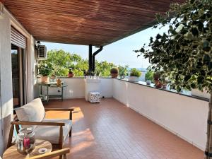 a patio with a table and chairs on a balcony at La casetta bellevue suite in Torre del Greco