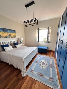 a bedroom with a large bed and a rug at La casetta bellevue suite in Torre del Greco
