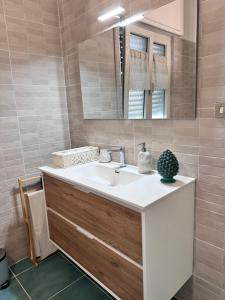 a bathroom with a sink and a mirror at La casetta bellevue suite in Torre del Greco +14 photos