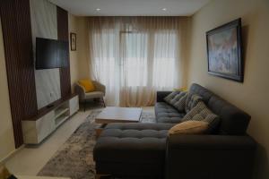 a living room with a couch and a tv at Rabat Easy Access in Rabat