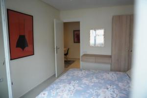 a bedroom with a bed and a window at Rabat Easy Access in Rabat