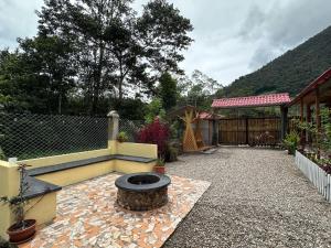 a backyard with a fire pit and a fence at La posada del Minero - Oxapampa in Oxapampa +4 photos