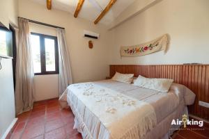 a bedroom with a bed in a room with a window at Hotel Boutique con Desayuno in Tafí del Valle
