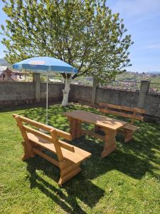 a picnic table and an umbrella on the grass at Europe Bosnia in Sarajevo