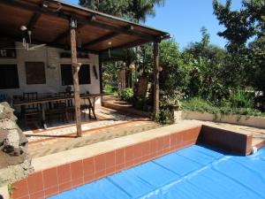 a swimming pool with a pavilion in a backyard at Vitral Cabaña Kindgreen in Oberá
