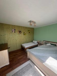 a bedroom with two beds and a ceiling fan at Habanero apartmány in Vrútky
