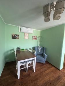 a dining room with a table and a chair at Habanero apartmány in Vrútky +20 photos