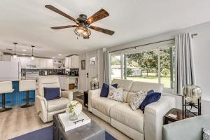 a living room with a couch and a ceiling fan at Withlacoochee River Retreat with Dock Paddle and Fish in Dunnellon