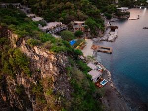 an aerial view of a river with houses and a mountain at Perla Roca Hotel Boutique - Beach Front in Santa Marta