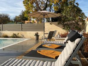 a table with an umbrella next to a pool at Weekend House Alsóörs in Alsóörs