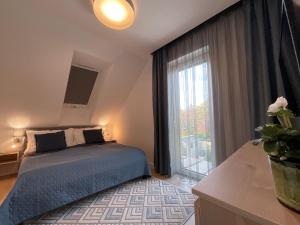 a bedroom with a bed and a large window at Weekend House Alsóörs in Alsóörs