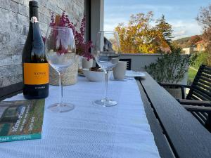 a table with two wine glasses and a bottle of wine at Weekend House Alsóörs in Alsóörs +3 photos