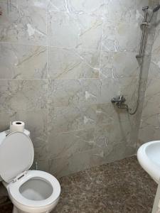 a bathroom with a toilet and a sink at Guest House Tobuldar in Kʼveda Marghi +58 photos