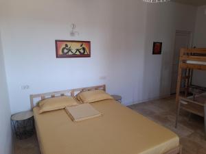 a bed in a room with a picture on the wall at Casa IRI - plaja Corbu in Corbu