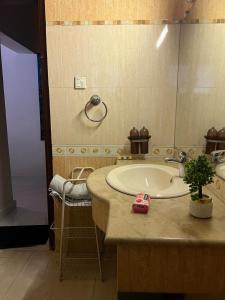 a bathroom with a sink and a large mirror at The Vaulted Retreat! F7 in Islamabad +31 photos