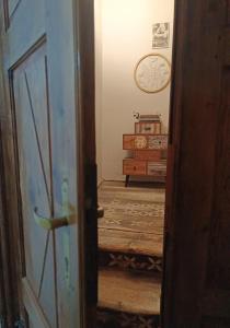an open door to a room with a clock on the wall at Apartmán u Smolena in Kežmarok