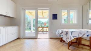 a kitchen with a table with a table cloth on it at Onnis Home Stay in Villasimius