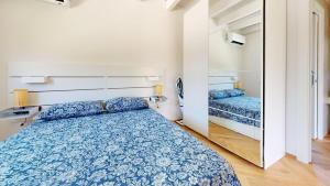 a small bedroom with a bed and a mirror at Onnis Home Stay in Villasimius