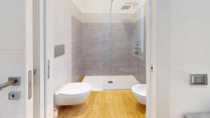 a white bathroom with a toilet and a shower at Onnis Home Stay in Villasimius